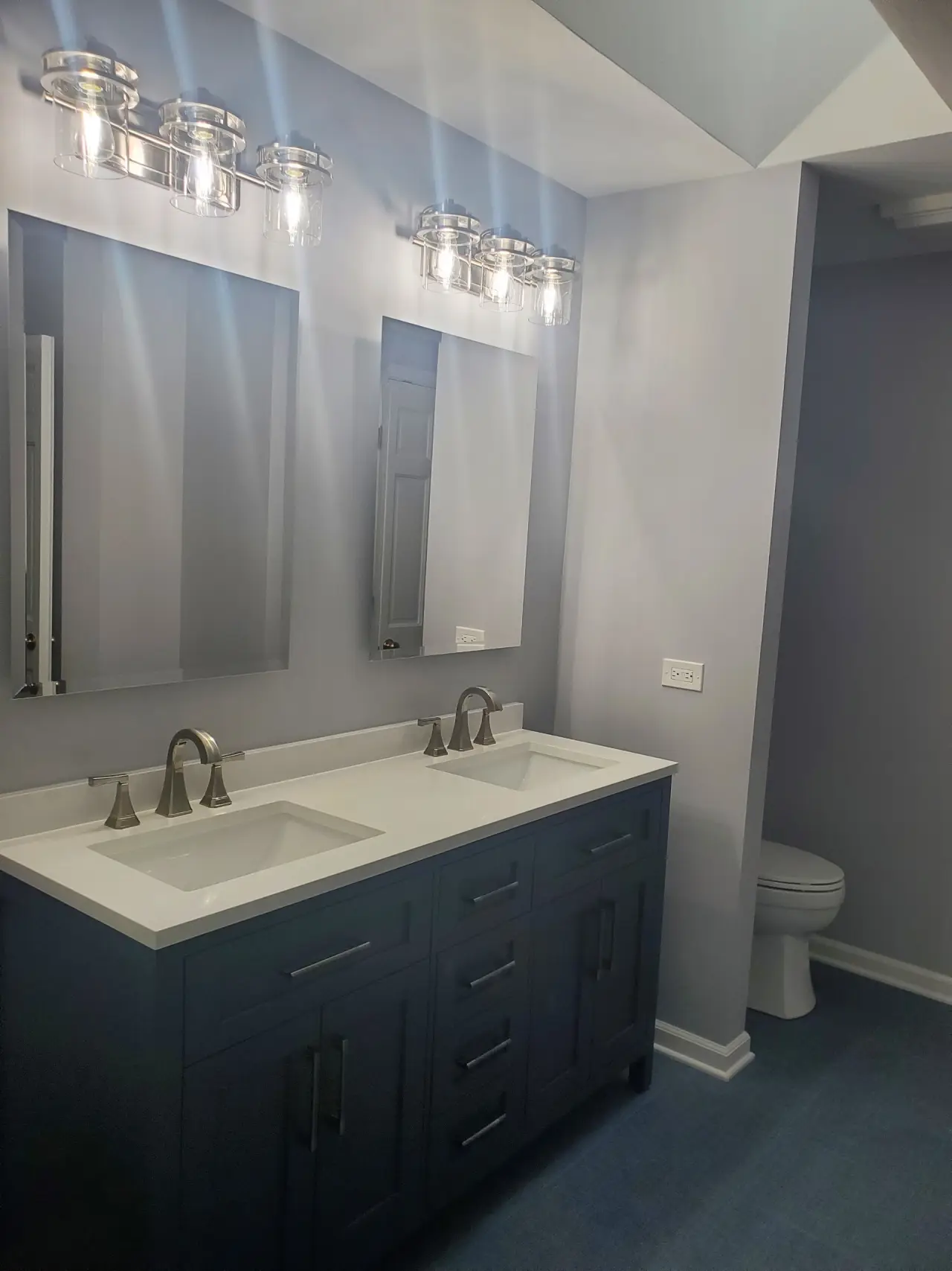 After: Single oak vanity to a navy double vanity